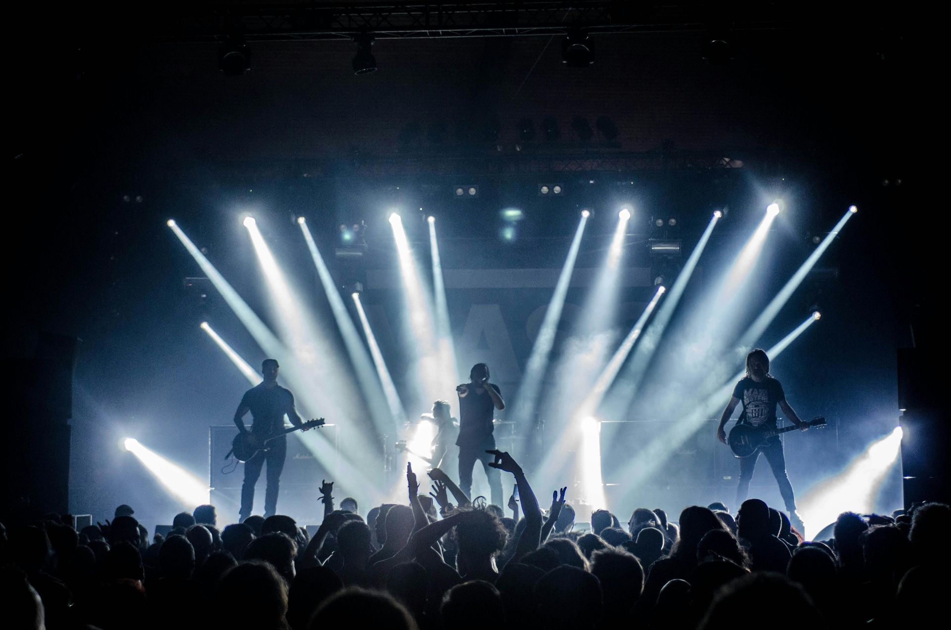A group of people are standing on a stage in front of a crowd.