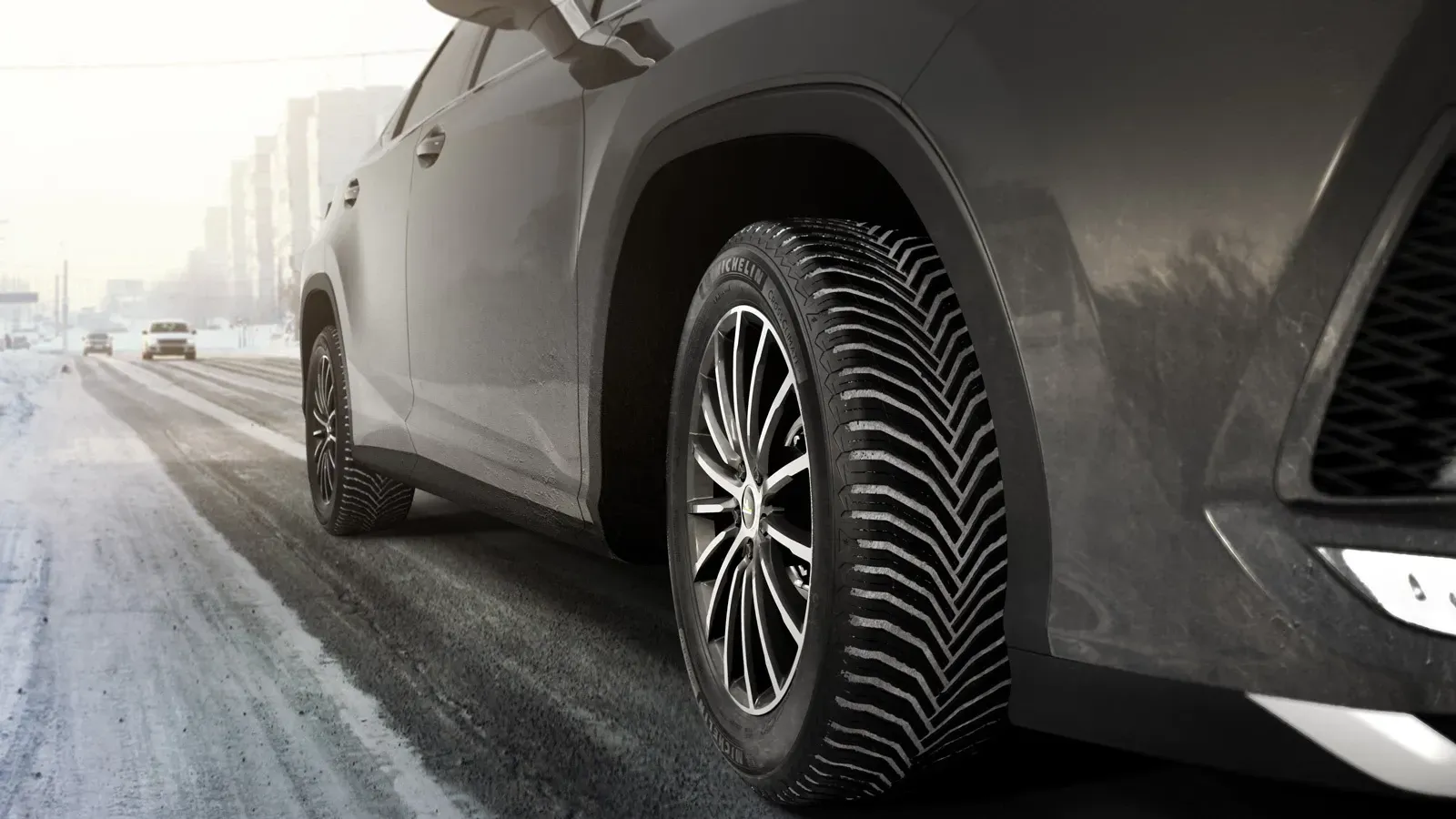 a close up of a car 's tire on a snowy road .