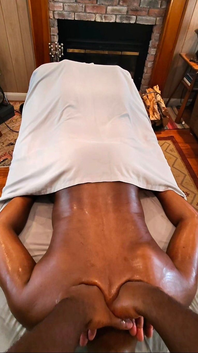 Hands massaging a bare back on a spa table Hands massaging a bare back on a spa table