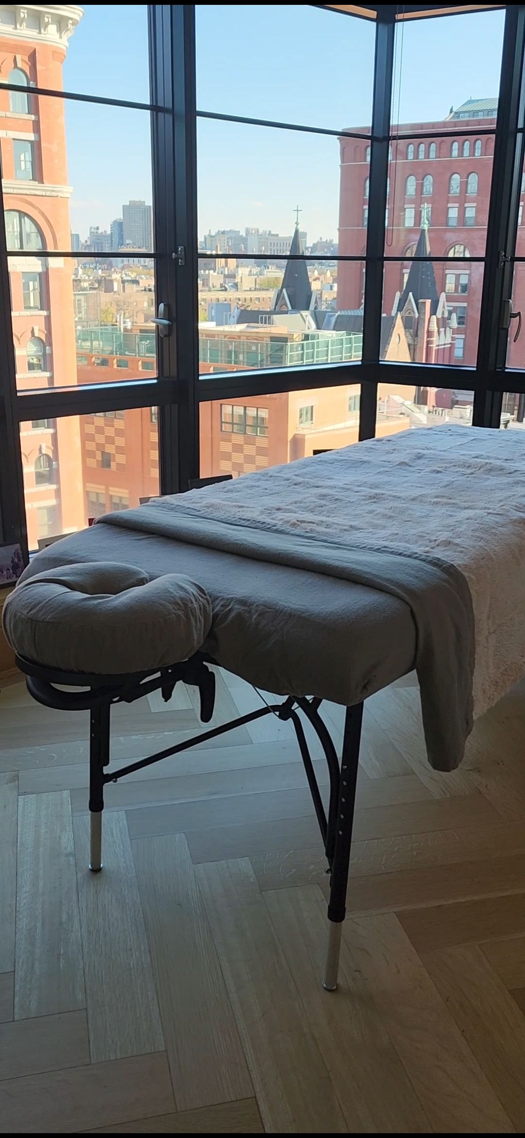 Woman receiving a spa massage with lit candles in a warm, relaxing room