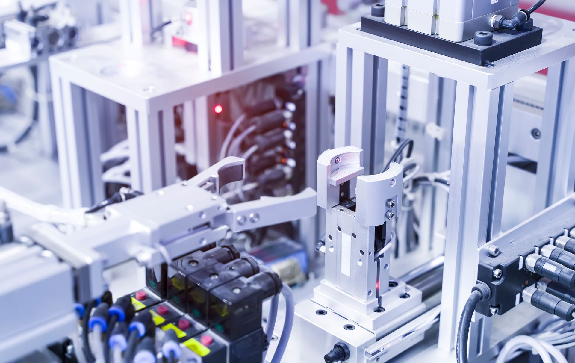 Automated factory machine with robotic arms assembling parts on a production line
