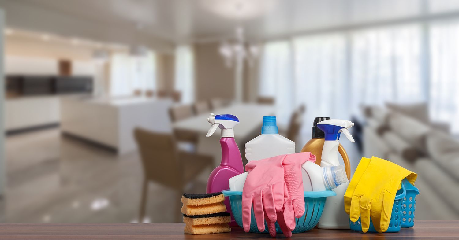 Cleaning supplies arranged before cleaning a living room.
