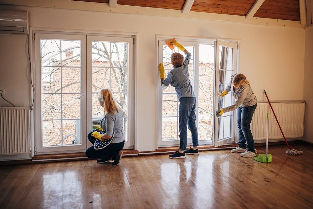 Workers Cleaning The Window In An Apartment - Houston, TX - All Premiere Service Solutions