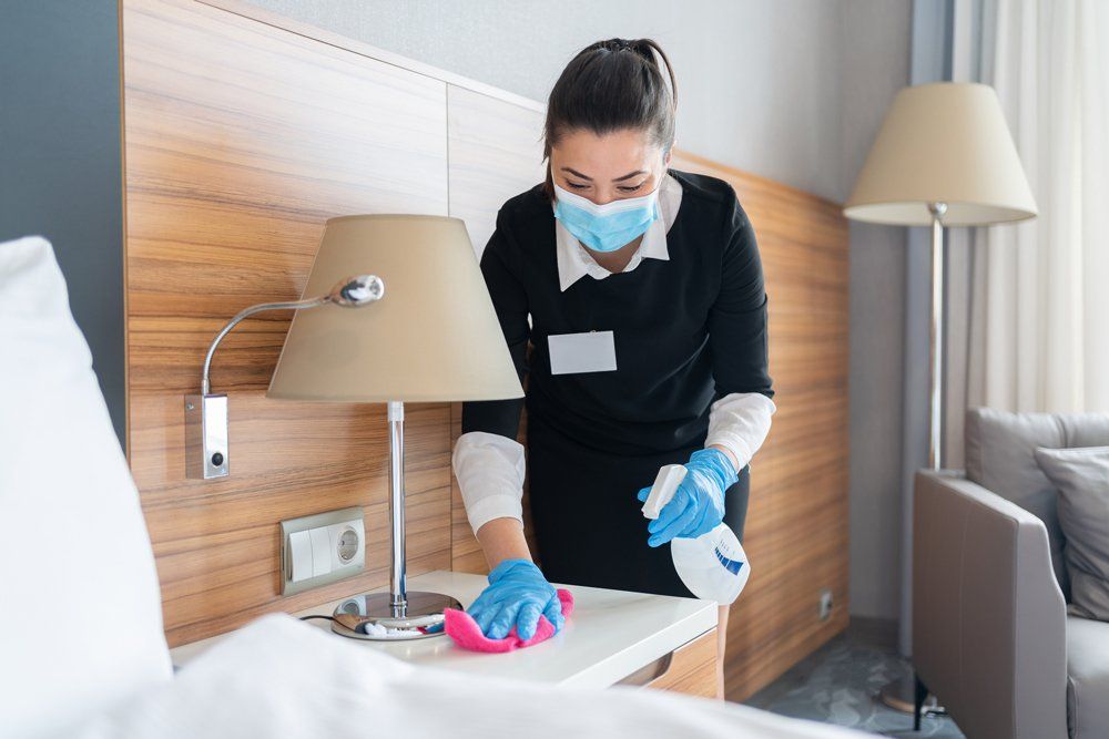 Female Worker Cleaning The Bedroom - Houston, TX - All Premiere Service Solutions Female Worker Cleaning The Bedroom - Houston, TX - All Premiere Service Solutions