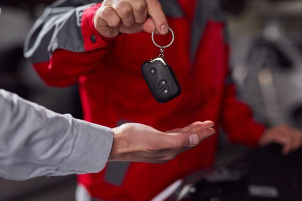 Our Mechanic Giving the Keys of a Fixed Car to a Customer - Green Tech Garage