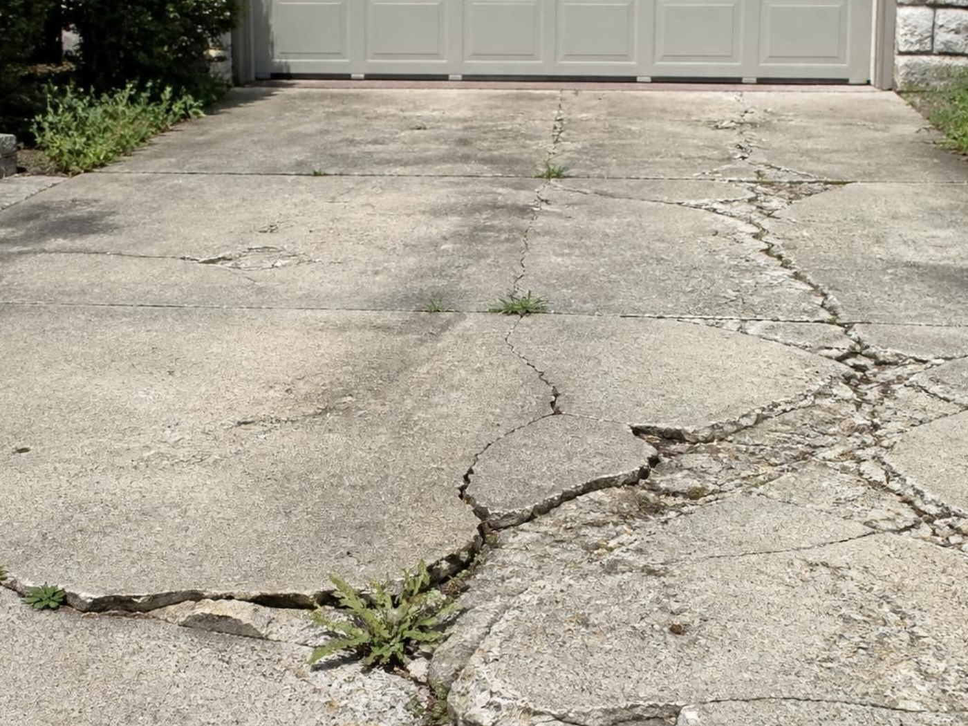 Cracks in the concrete driveway need to be repaired.