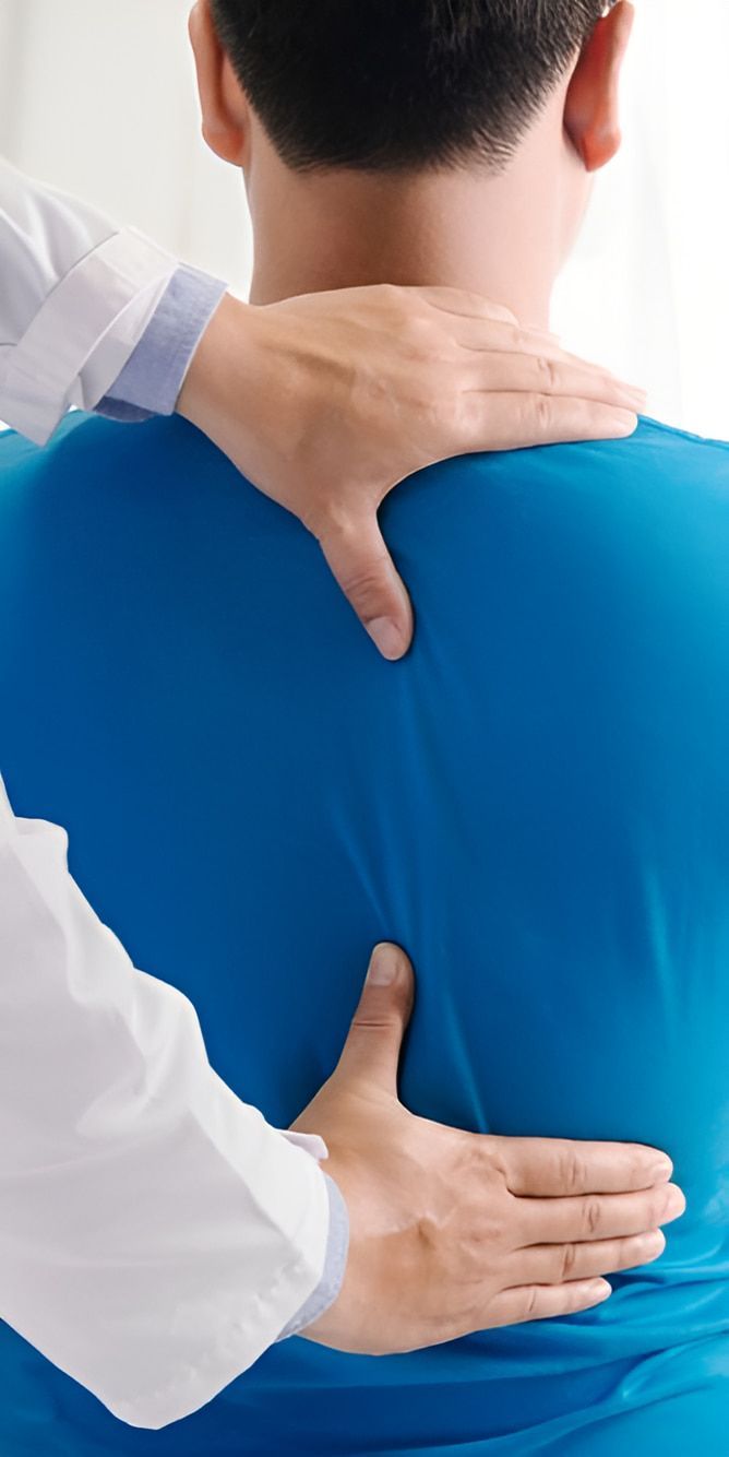 A Doctor Is Examining A Patient 's Back And Neck — Back In Motion Chiropractic & Healthcare In Mission Beach, QLD
