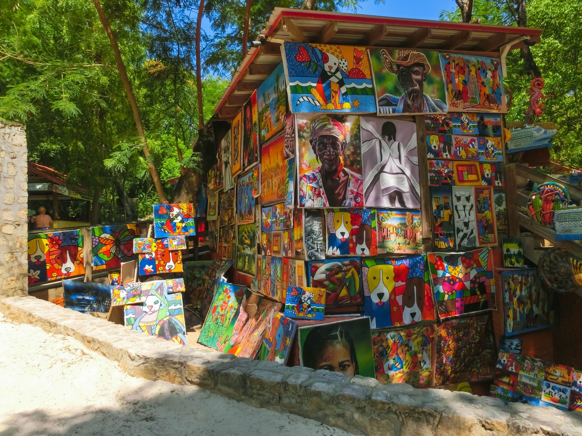 Colorful mosaic-covered roadside shack in a wooded outdoor setting