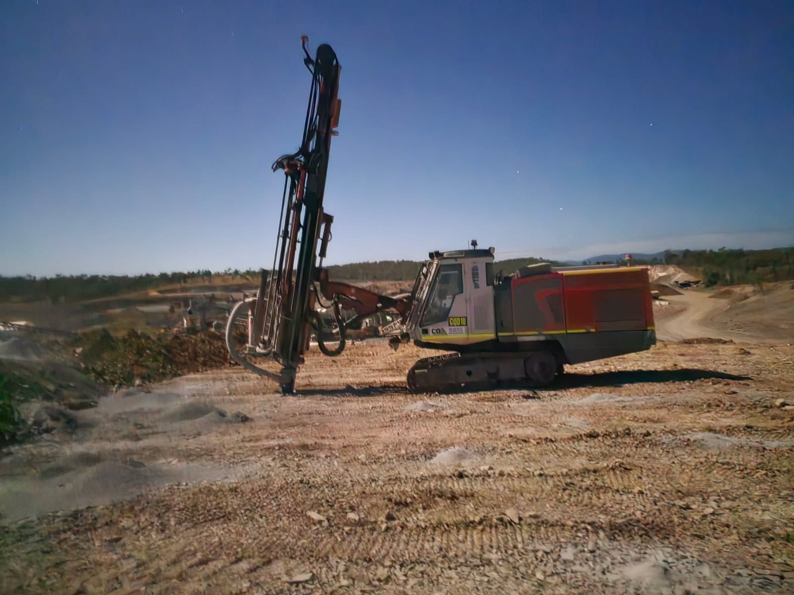 A large drill is being used to dig a hole in the ground.