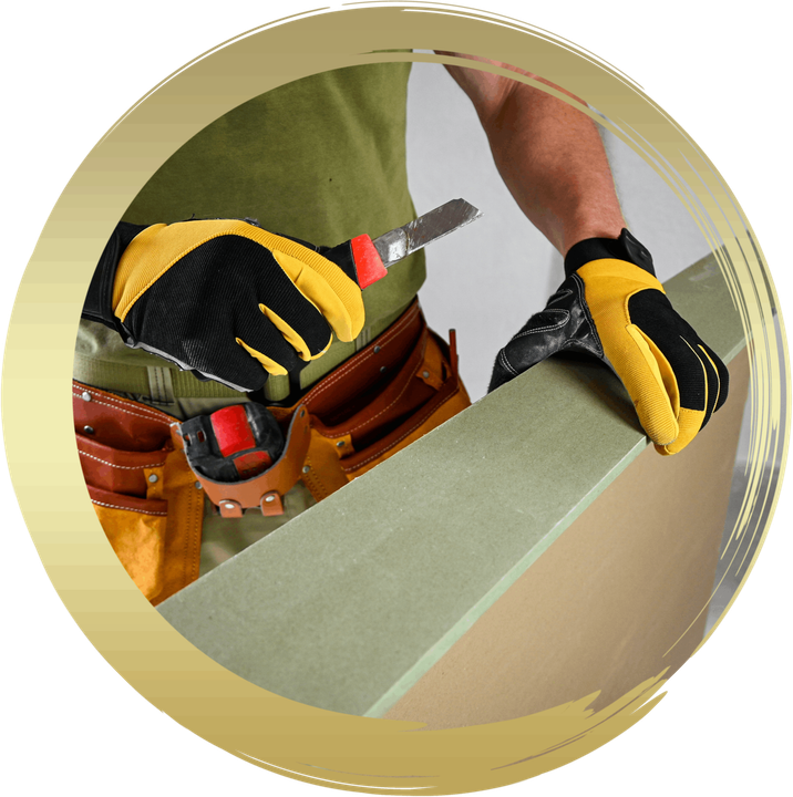 a man wearing gloves is cutting a piece of wood
