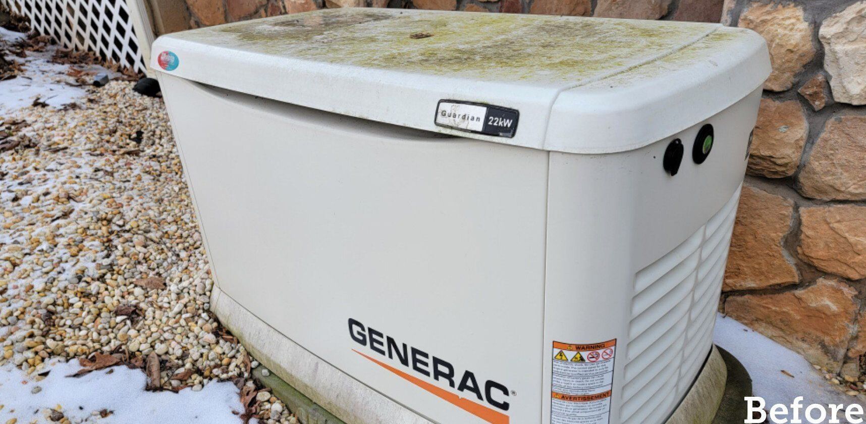 A Generac generator, tan with algae on top, sits on a stone base in front of a stone wall.