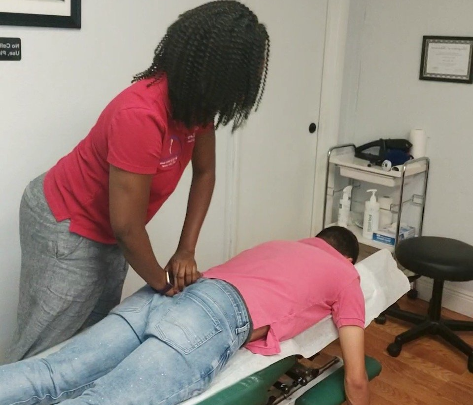Patient Lying on Blue Exercise Ball — Margate, FL — Light of Life Chiropractic, LLC Patient Lying on Blue Exercise Ball — Margate, FL — Light of Life Chiropractic, LLC