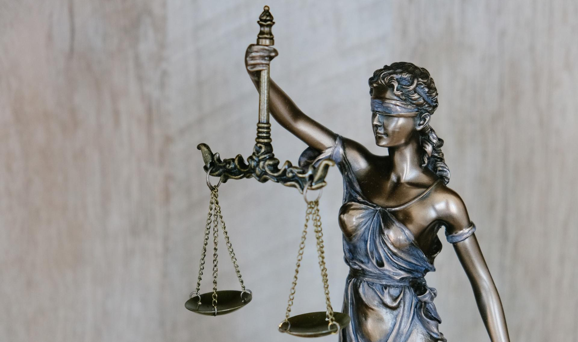 a statue of a blindfolded lady holding scales of justice