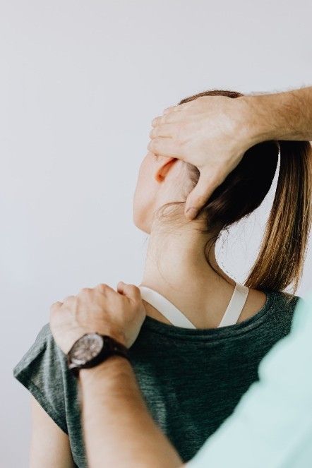 Person receiving a neck massage from a practitioner indoors