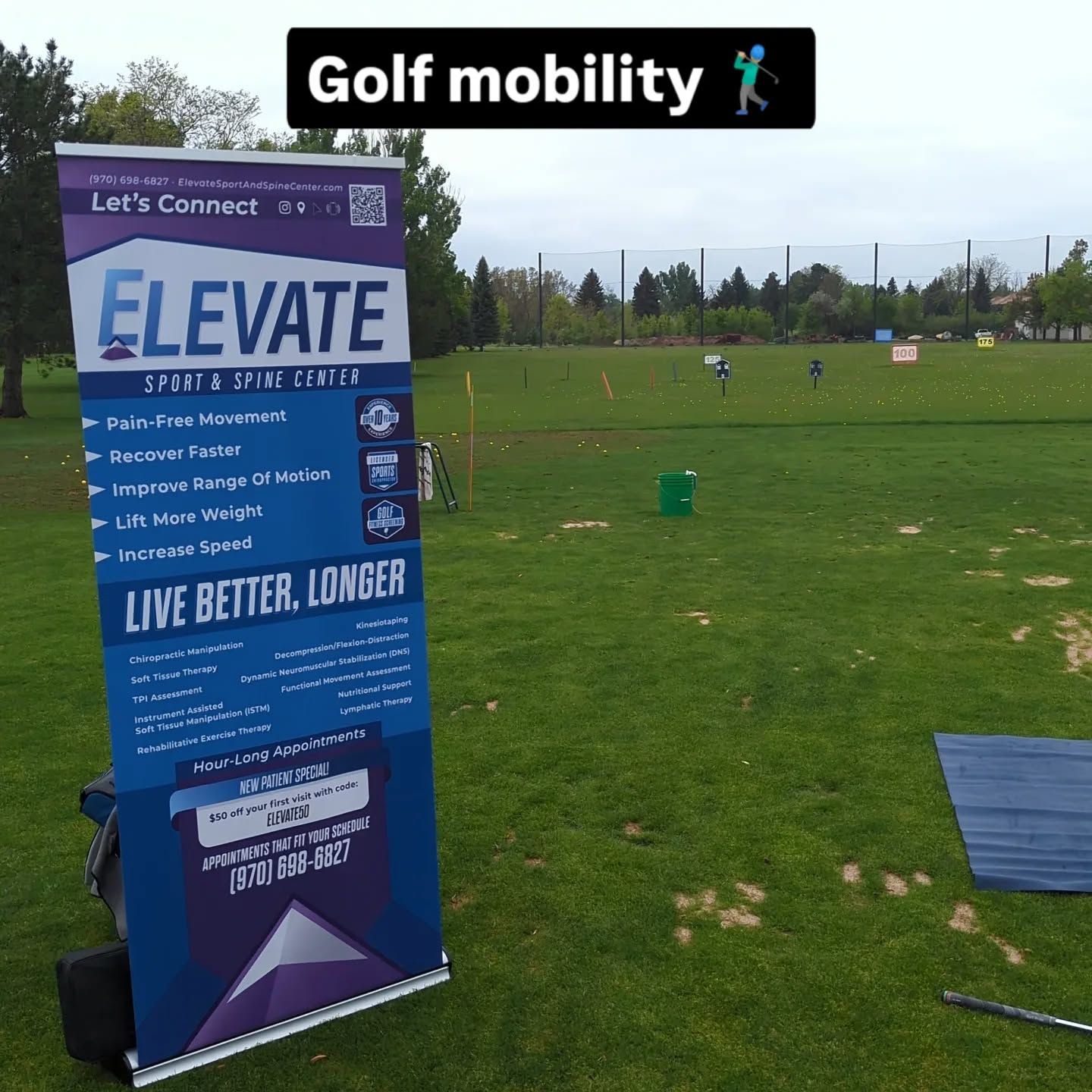 Golf driving range with an Elevate sign on a grassy field under a cloudy sky.
