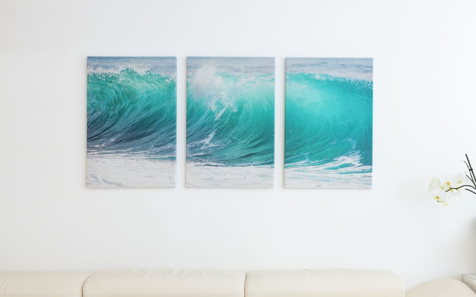 Three large canvas prints of wave on wall