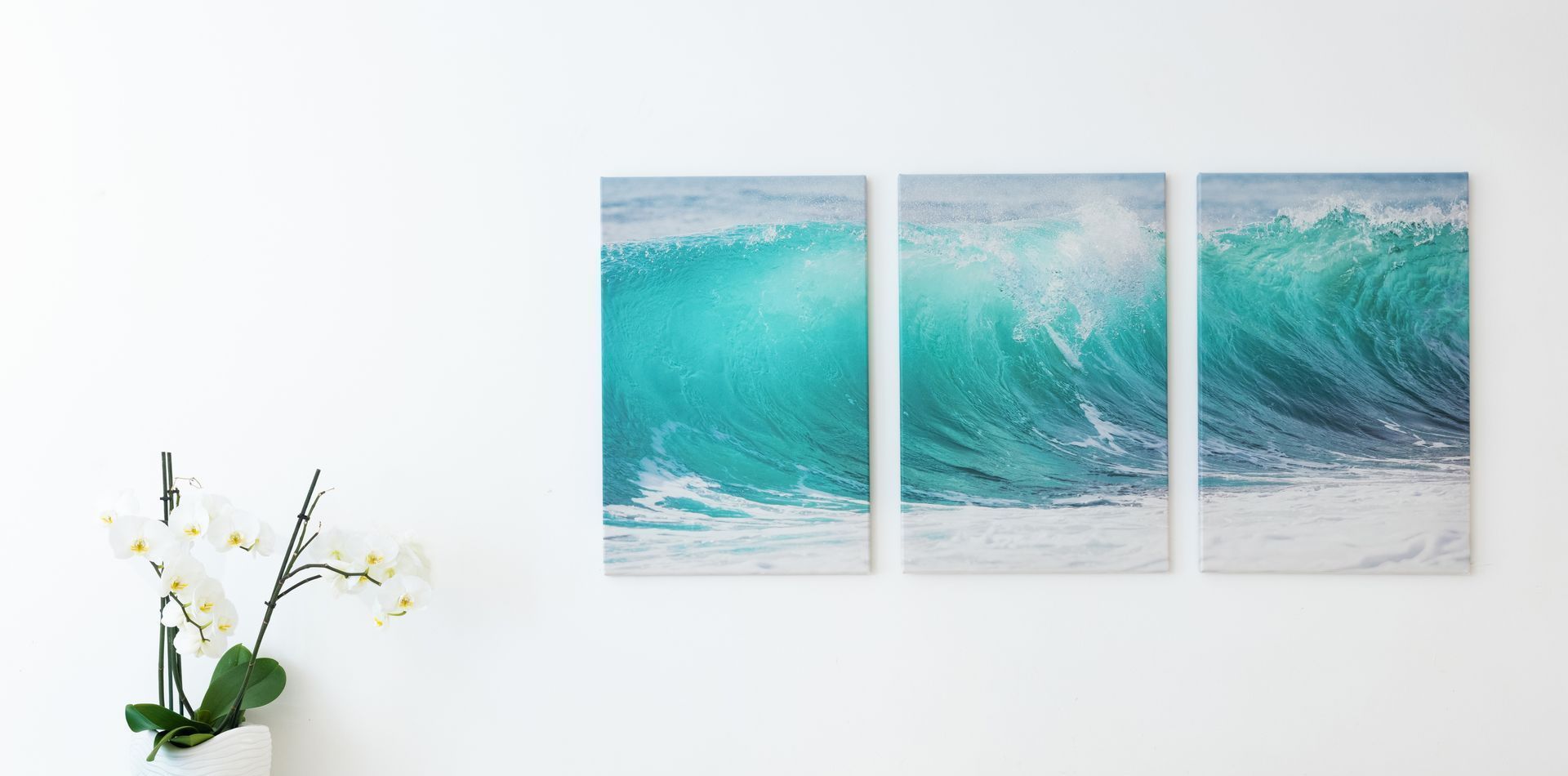 Three large canvas prints of wave on wall