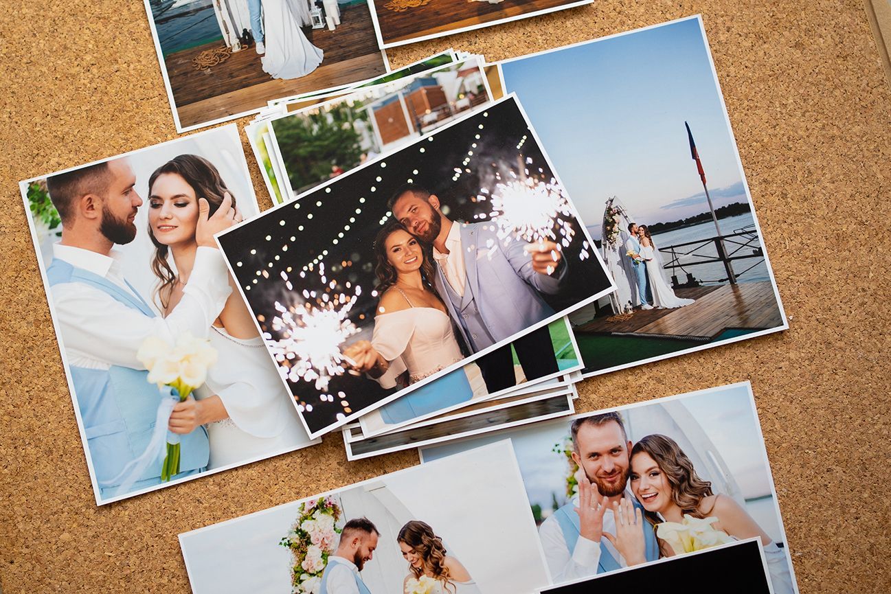 Online photo printing. Multiple photographs with white borders on bulletin board.