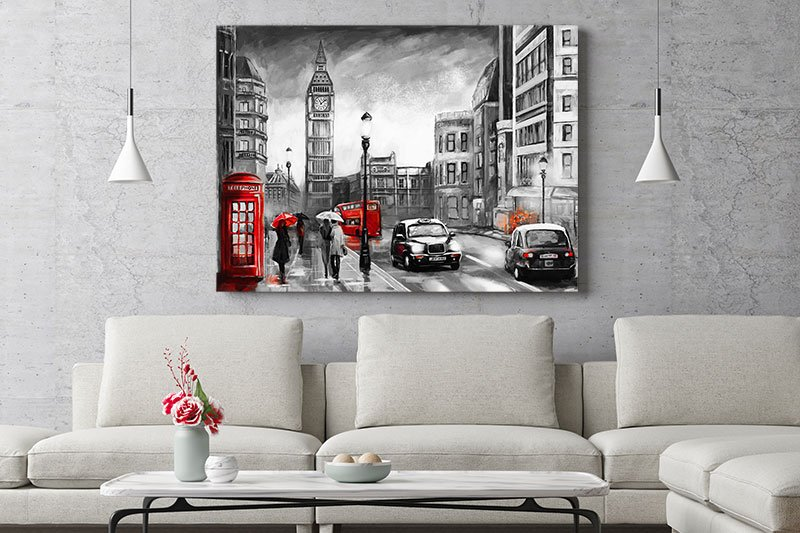 Large canvas of London hanging on wall behind grey couch.