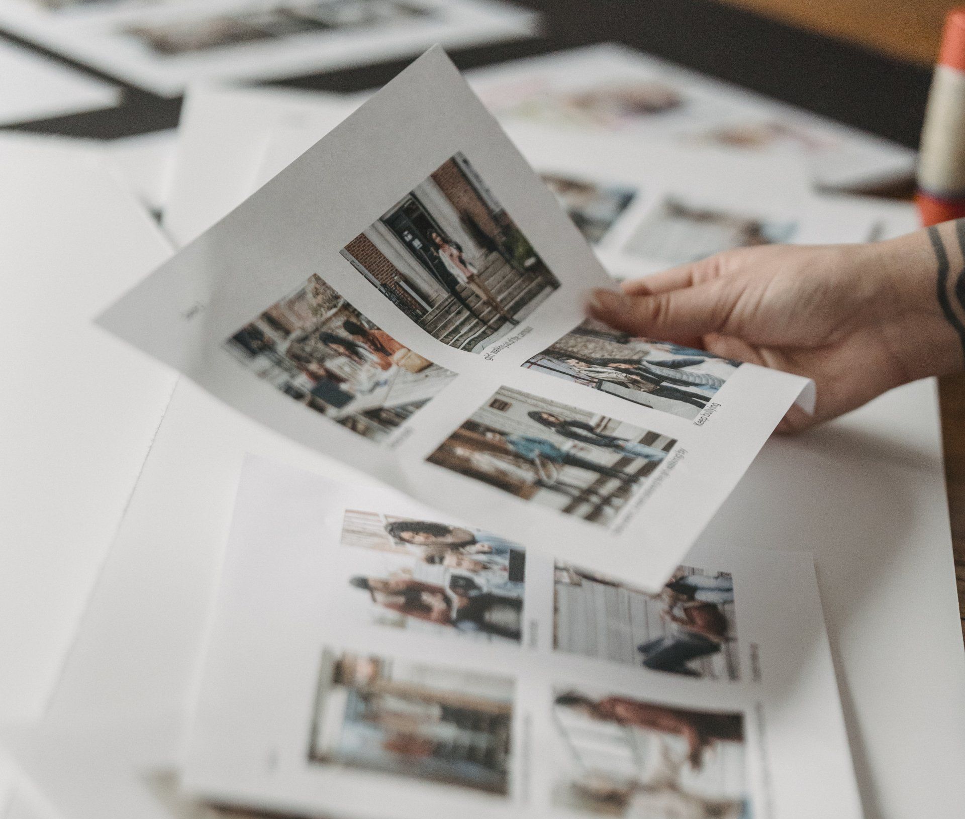 Woman holds photo proofs to be scanned
