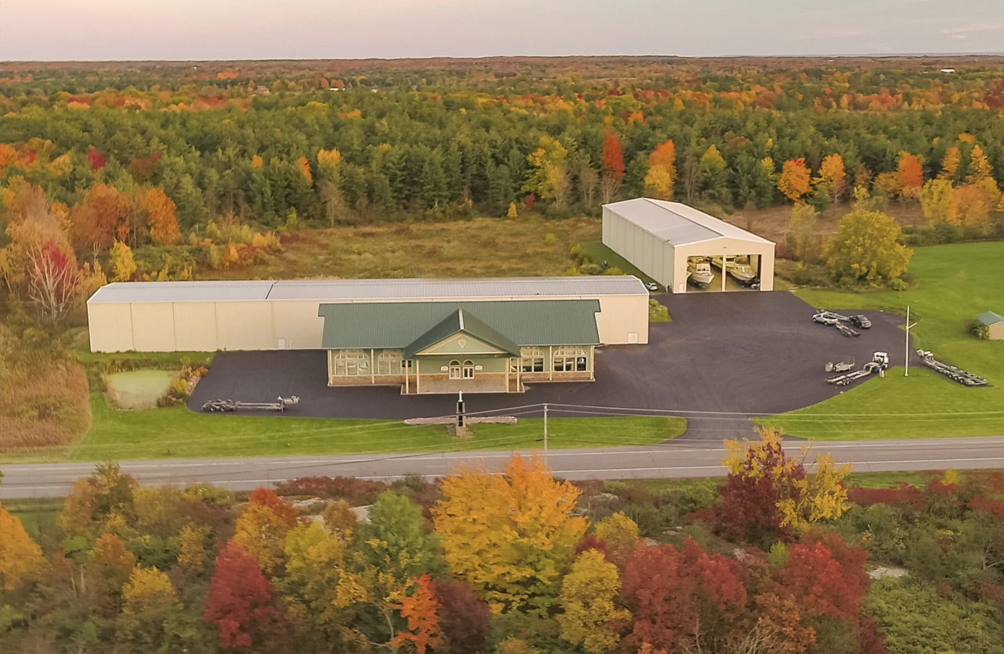 An aerial view of a large building in the middle of a forest.