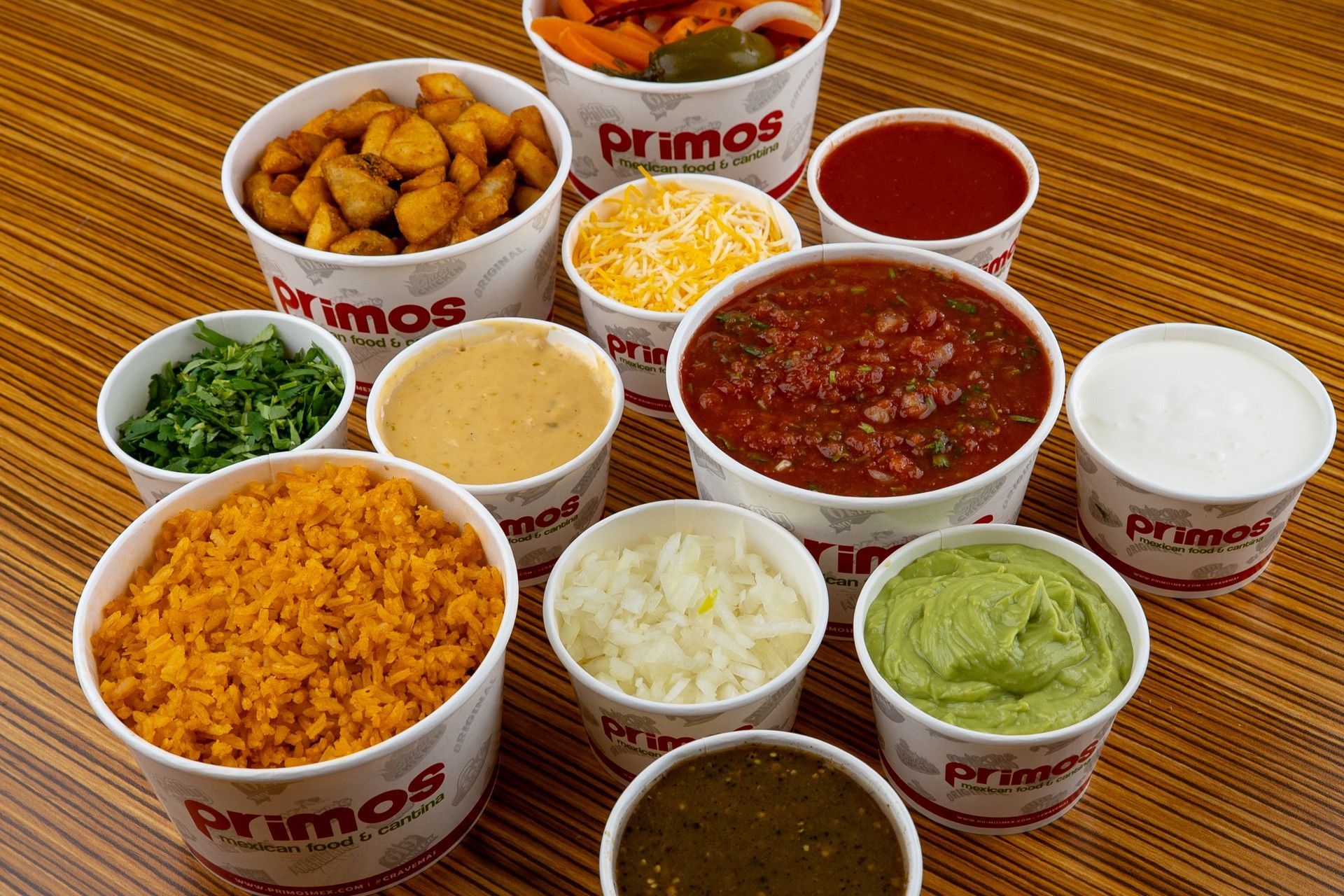 Bowls of food from Primos, including salsa, cheese, potatoes, and guacamole.