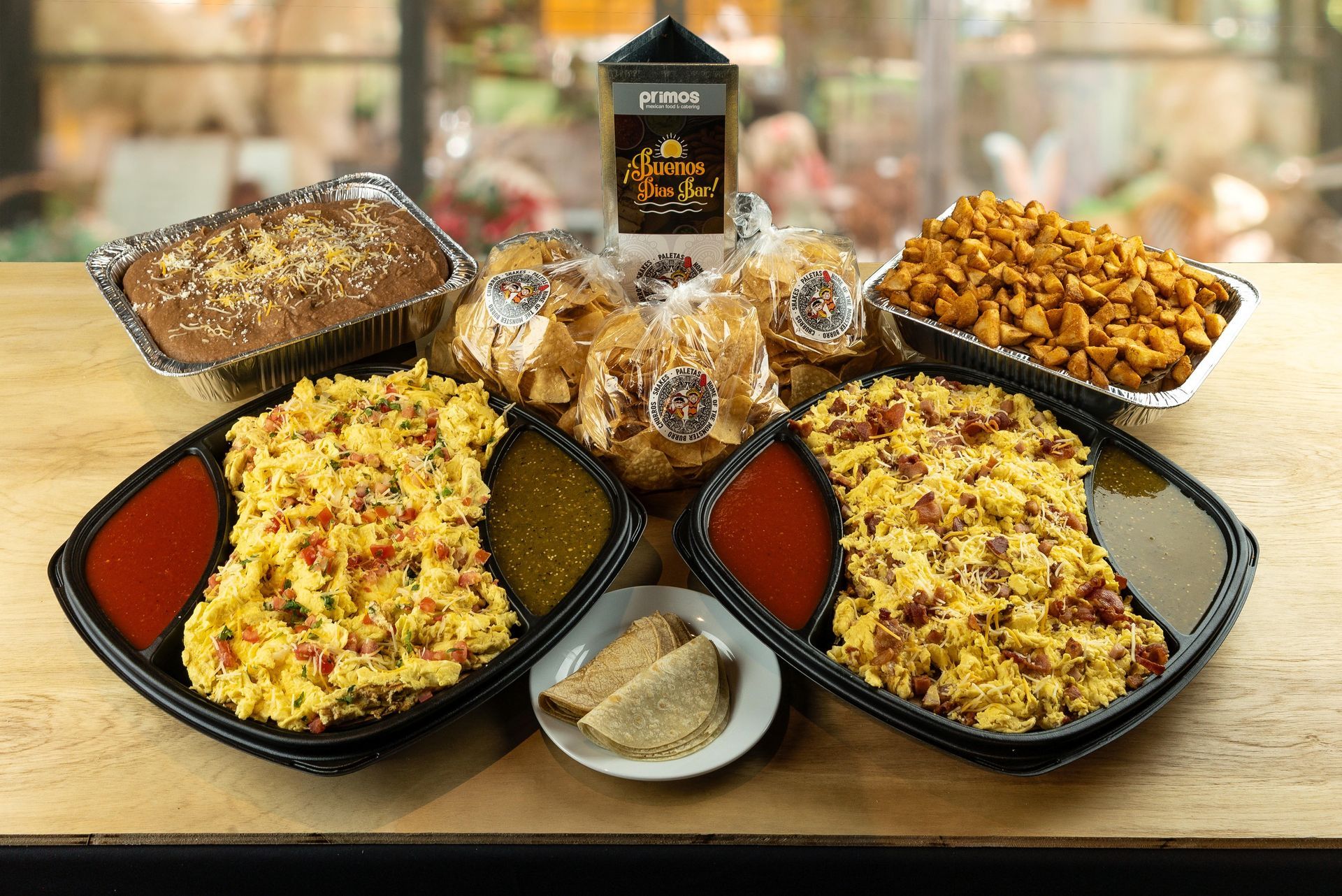 Assorted baked pasta dishes and pastries arranged on a table with a bottle in the center.