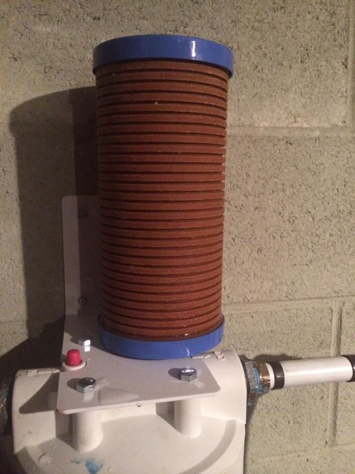A brown filter is sitting on top of a white device.