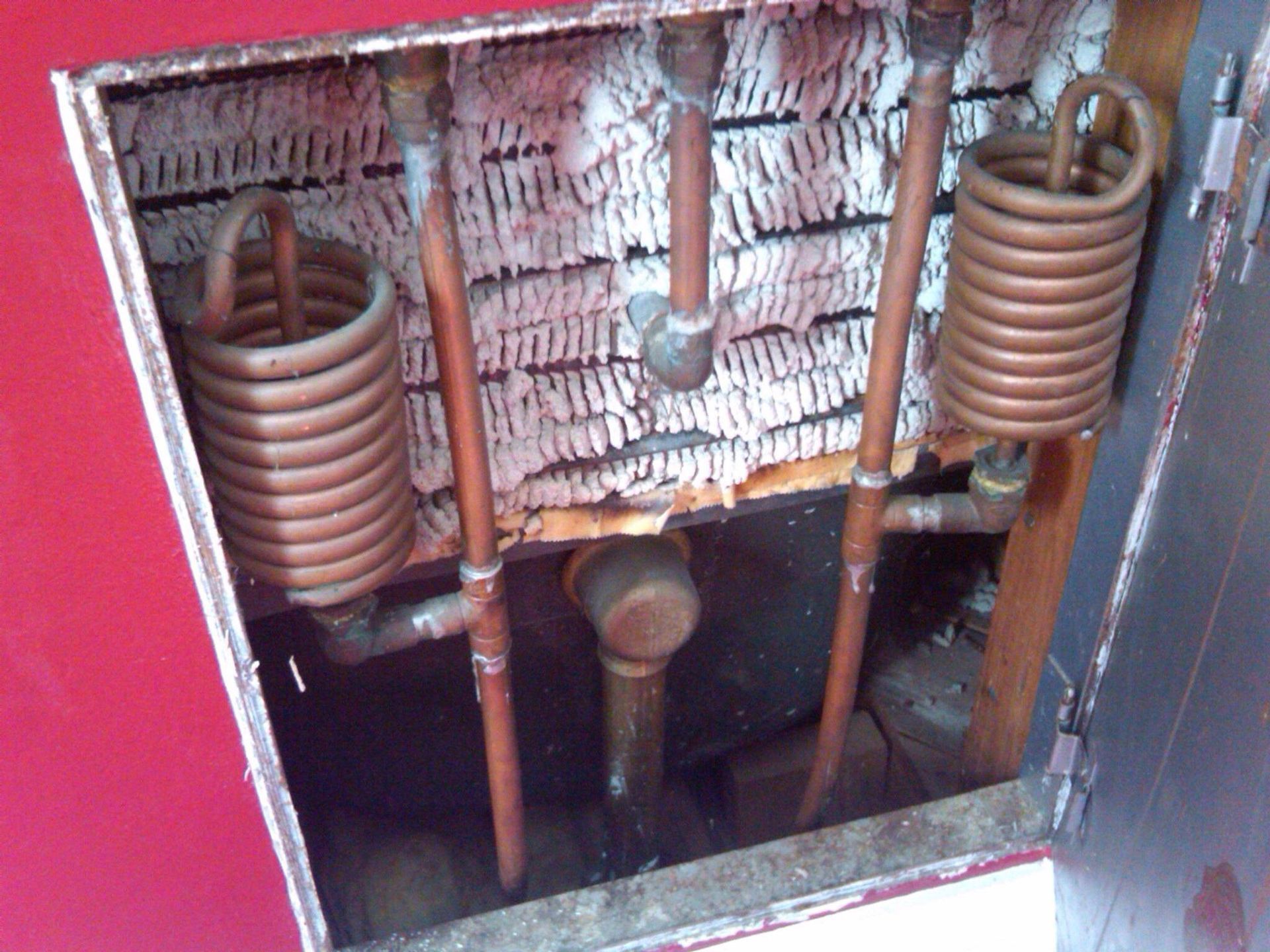 A close up of copper pipes in a room