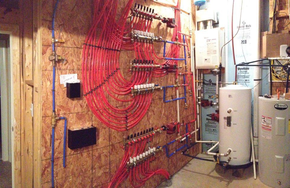 A room with a lot of pipes hanging on the wall