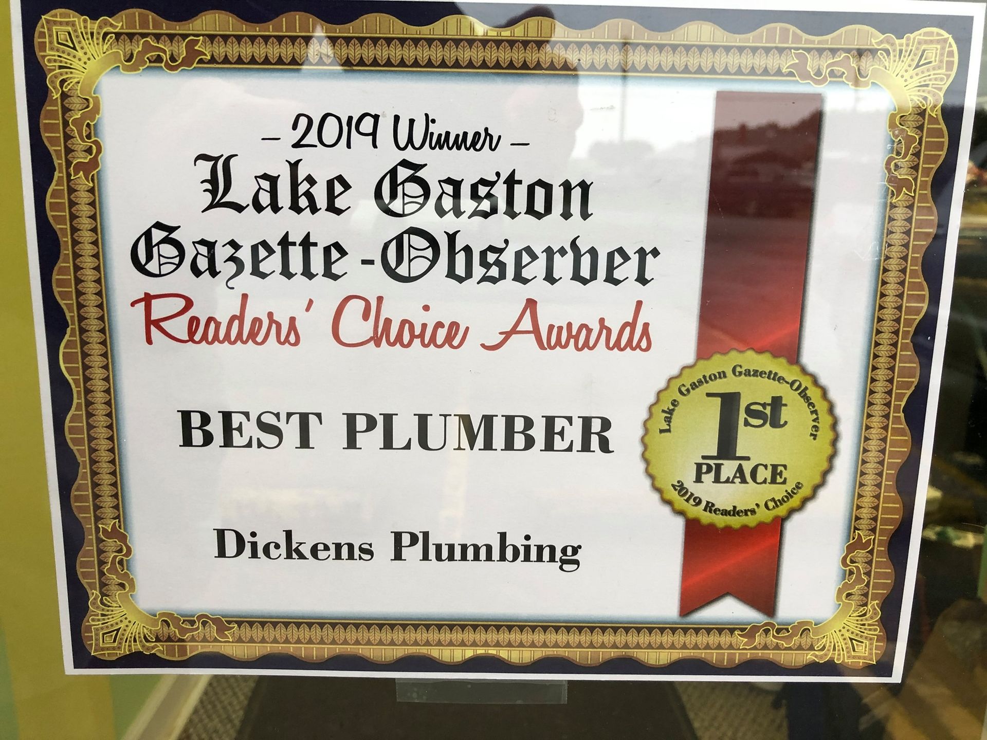 A framed sign that says best plumber on it