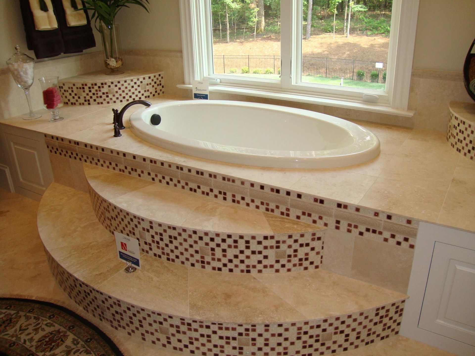 A bathtub in a bathroom next to a window