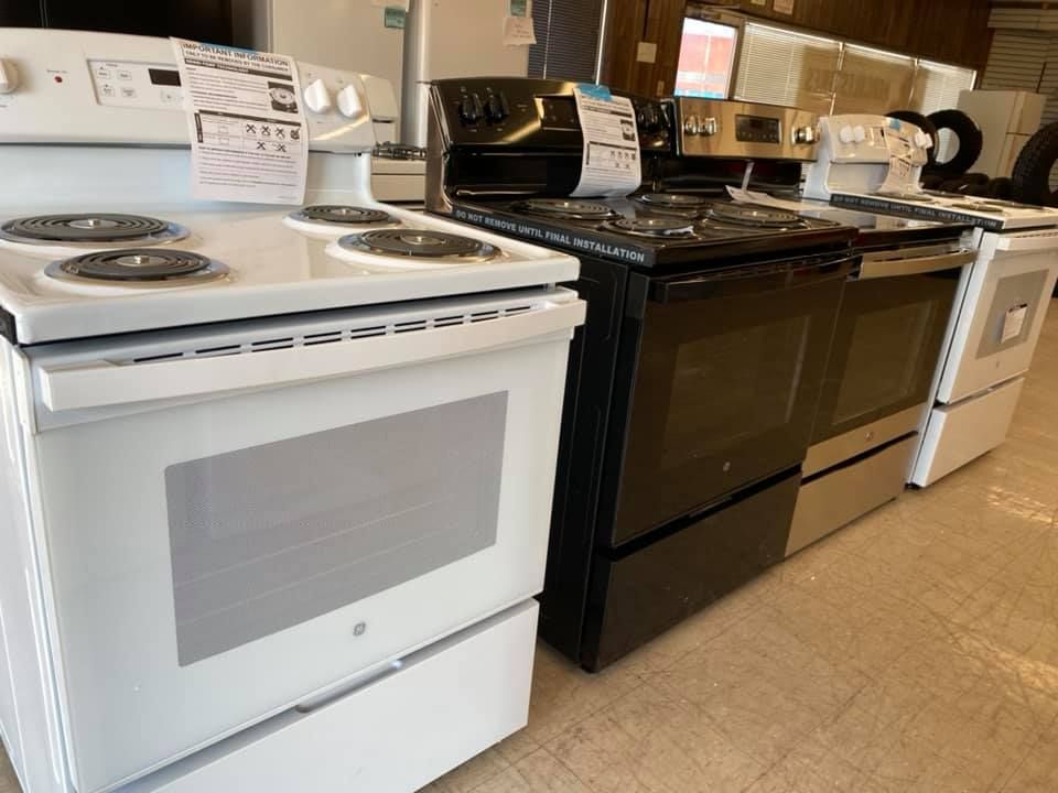 Kitchen showroom with white and black stoves on display