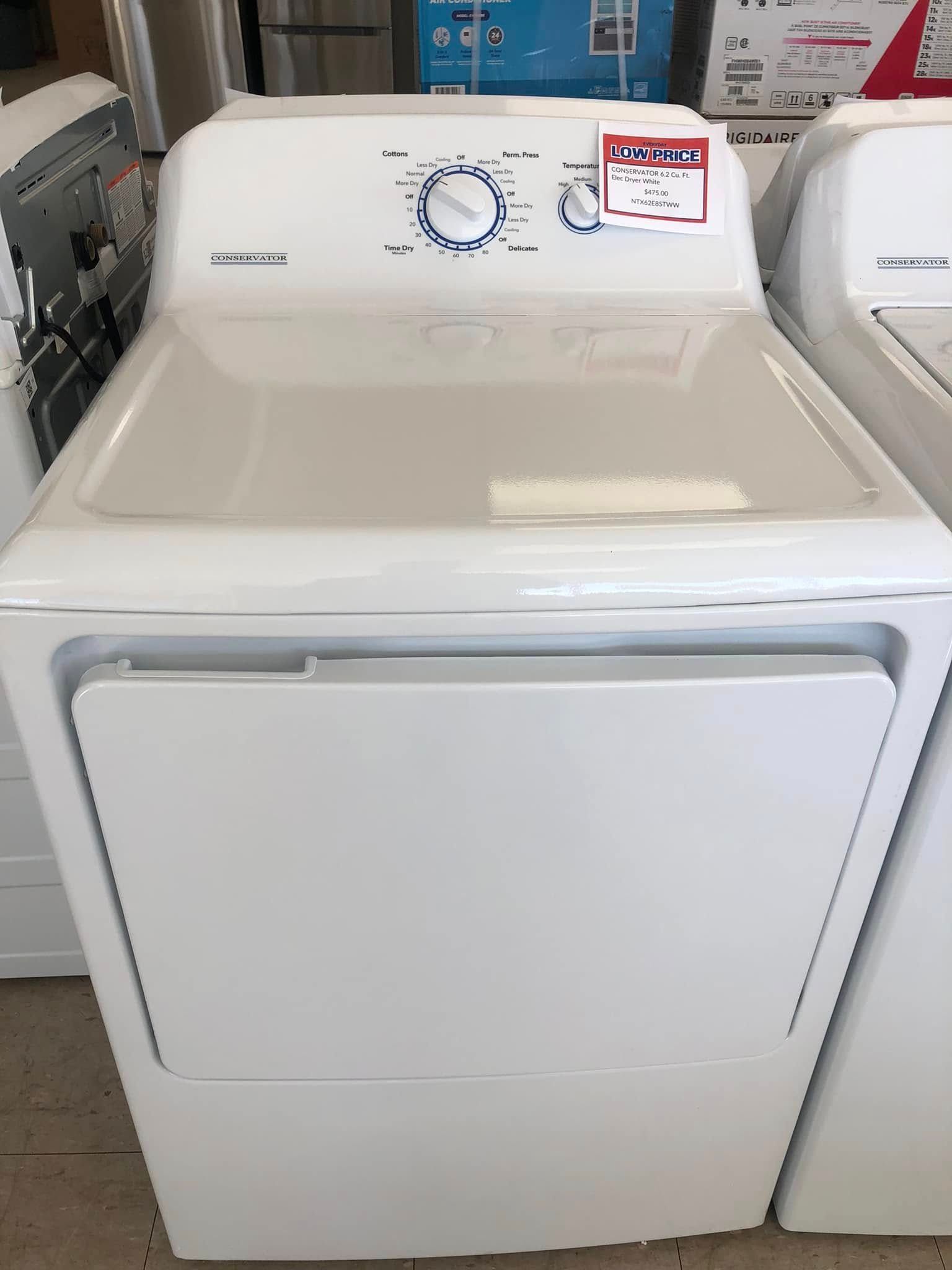 White front-load clothes dryer with two dials, displayed in a store aisle.