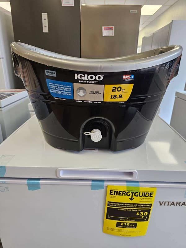Black IGLOO beverage dispenser on a store shelf with a yellow price tag below.