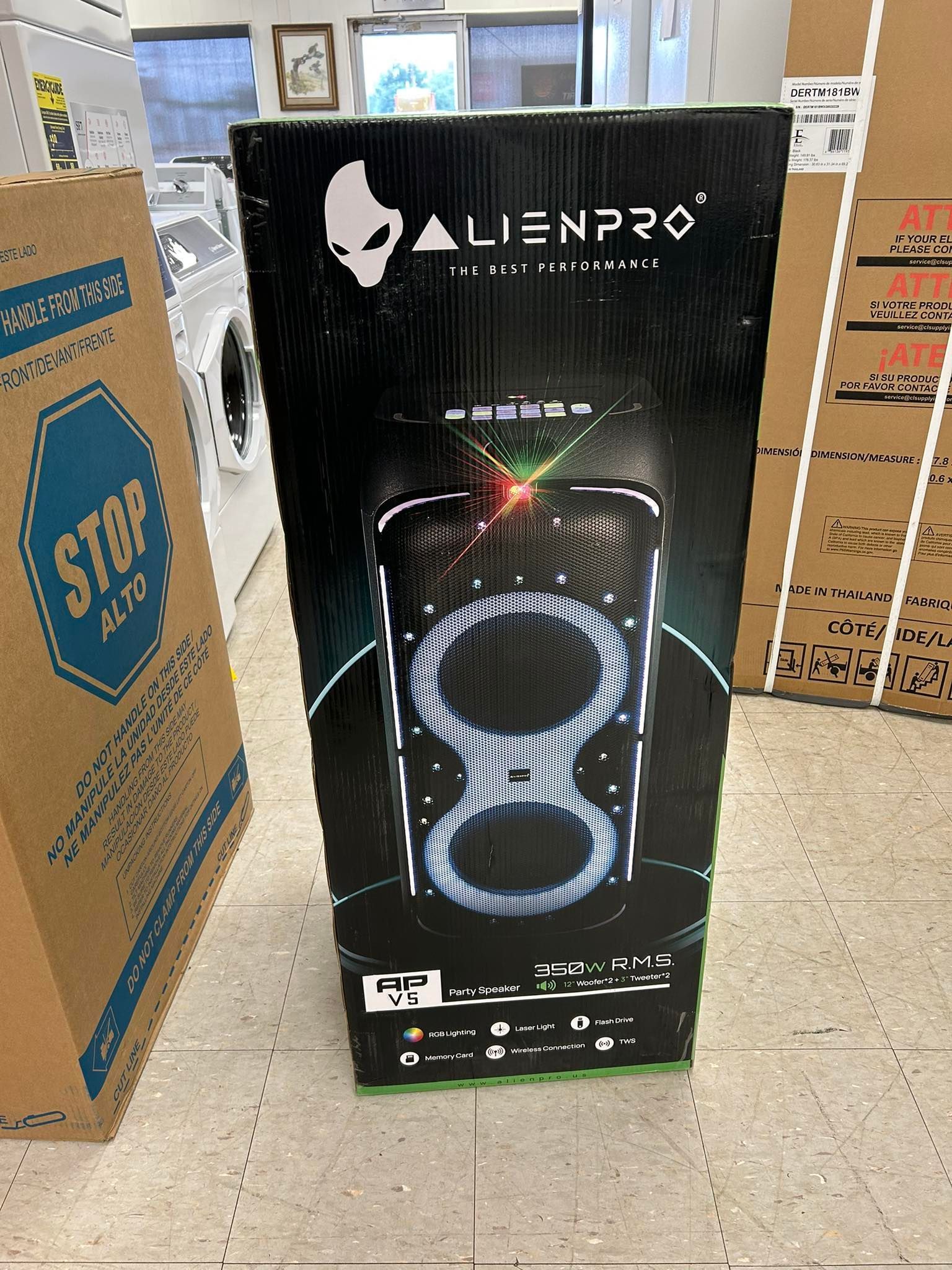 ALIENPRO LED tower speaker box with glowing ring design, displayed in a store aisle