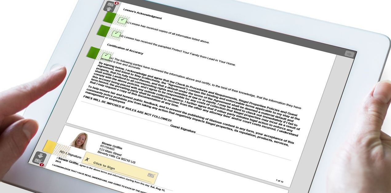 Hands holding a white tablet showing a web page with text and profile images.