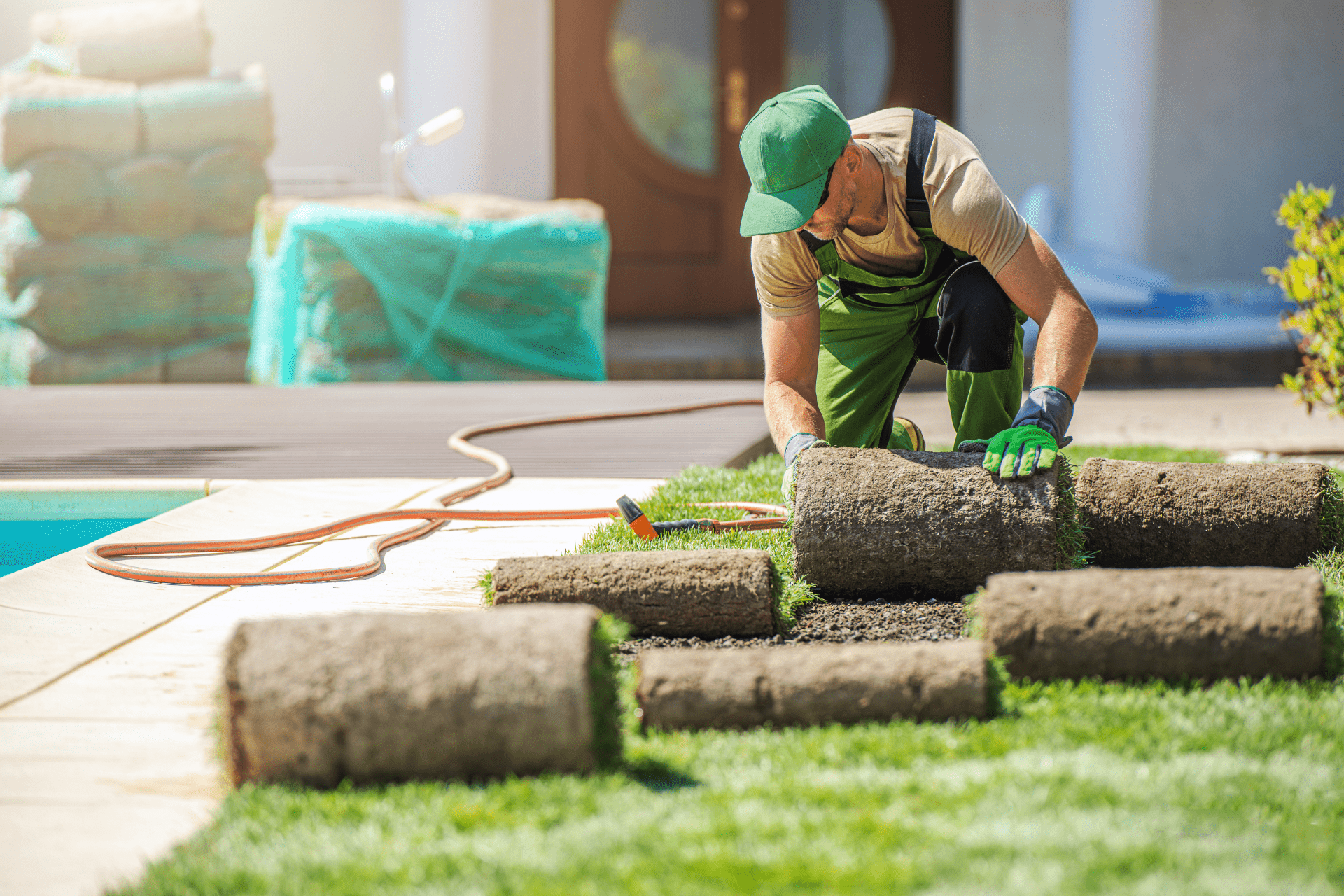 Our landscaper installing new artificial turfs in a garden