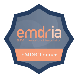 A badge that says ' emdr trainer ' on it