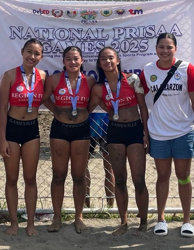 Four athletes with medals pose in front of a “National Prisaa 2025” banner.