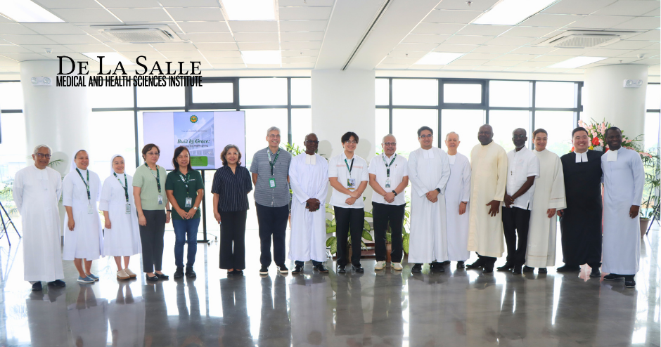 Group of students and staff in white uniforms standing in a bright school hallway