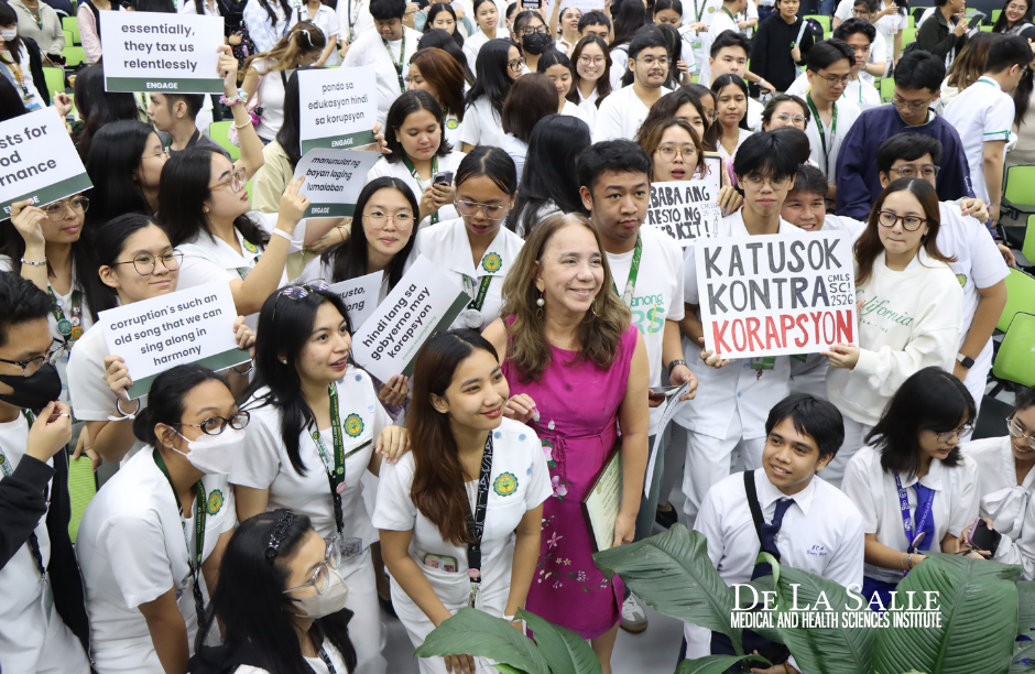Crowd of protesters holding signs, including one reading “KATULONG KONTRA KORAPSYON,” in a public rally