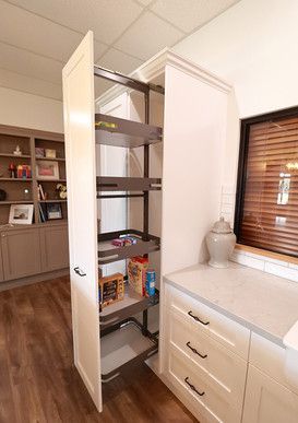 A kitchen with a pantry and a window.
