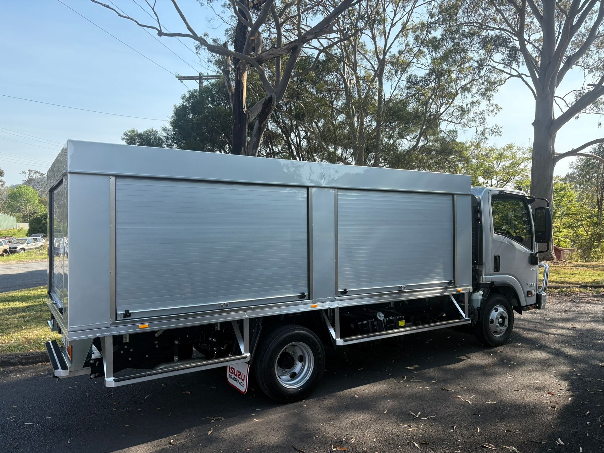 Aluminum Delivery Truck With Rolling Shutters On A Road — Soward Steel & Aluminium Fabrication in South Lismore, NSW