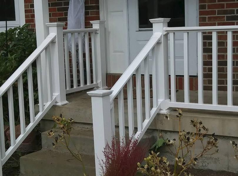 a white picket fence with a blue sky in the background