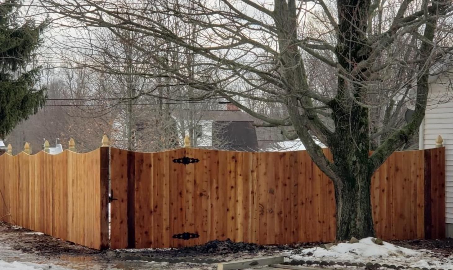 Wooden fence surrounding outdoor landscape, providing security and privacy.