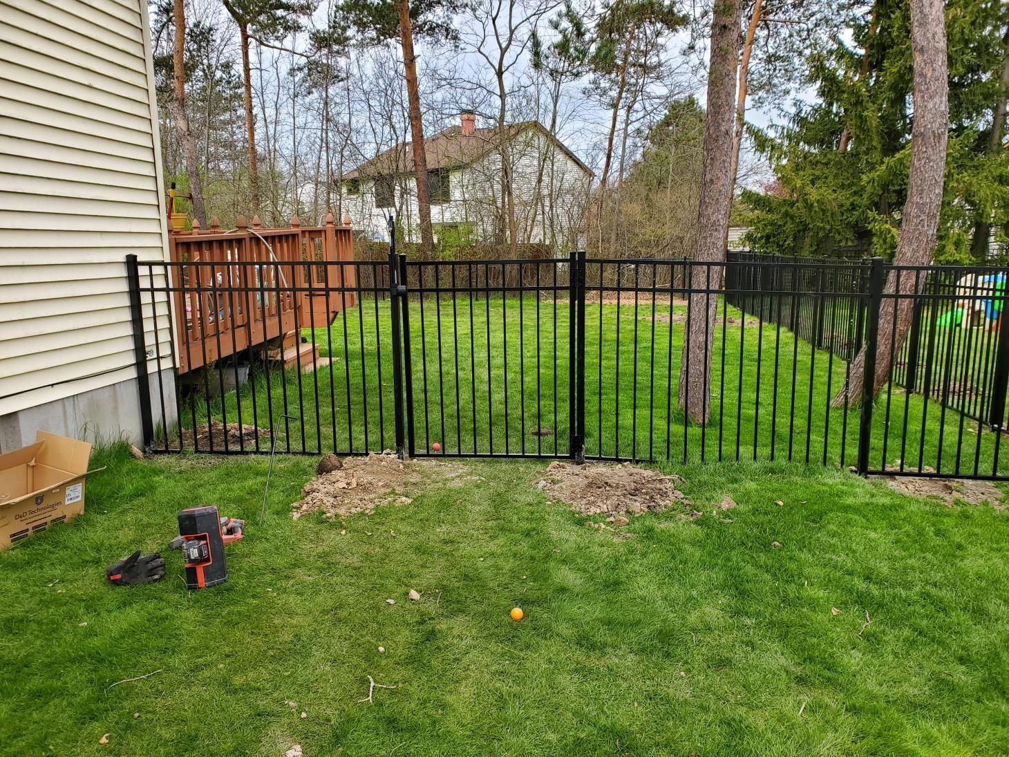 a white picket fence with trees in the background