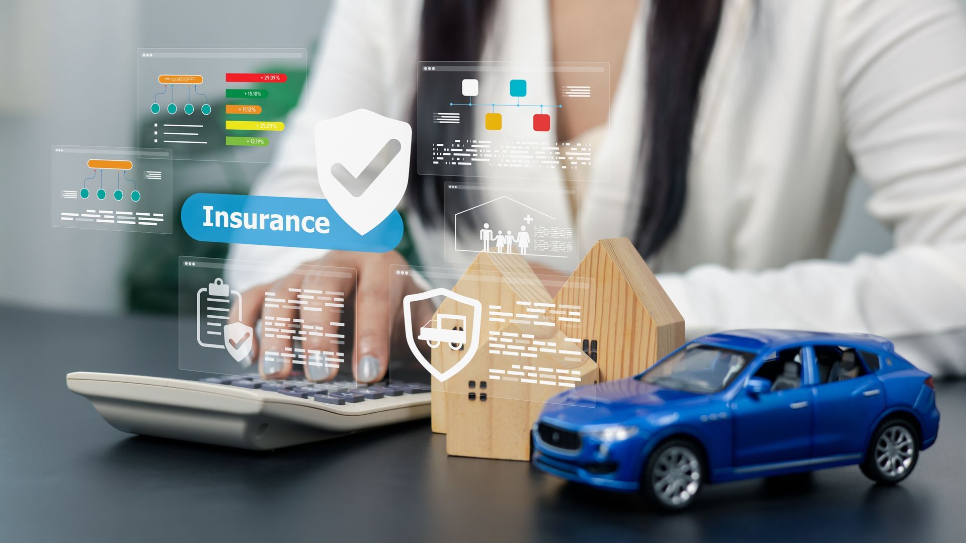 Insurance claim concept with laptop, house model, blue car, and digital finance icons