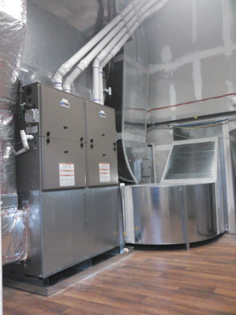 HVAC system in a room with metal ductwork, furnace, and wood-look flooring.