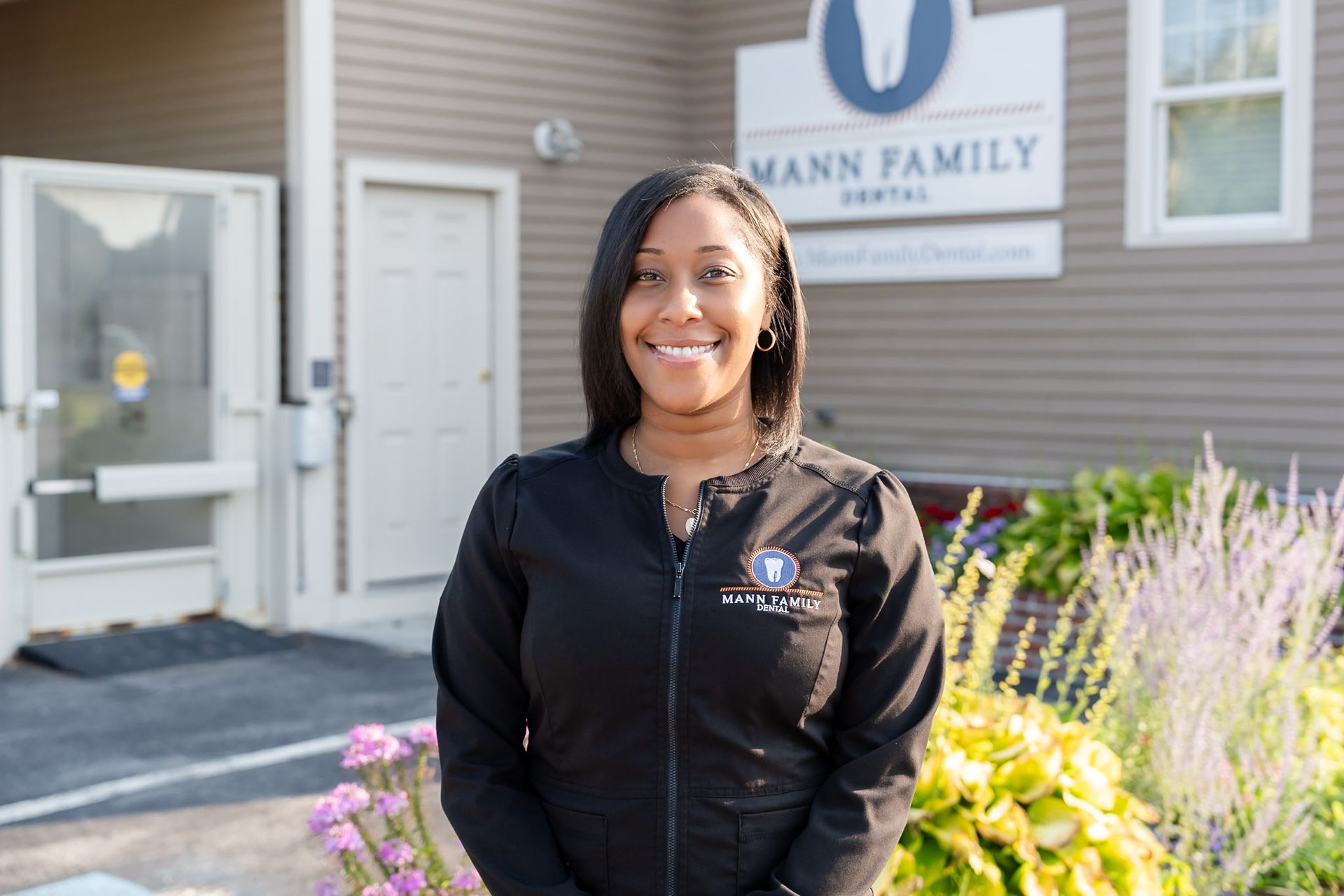 Smiling team member outside Mann Family Dental in Manchester, NH